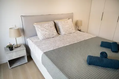 a bedroom with a large bed with two pillows at Elegant and cozy flat near Pagrati region (D1) in Athens