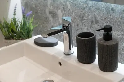a bathroom sink with a faucet and two towels at Elegant and cozy flat near Pagrati region (D1) in Athens