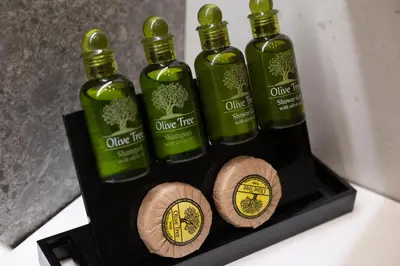 three bottles of olive tree on a black box at Elegant and cozy flat near Pagrati region (D1) in Athens