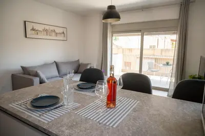 a dining room table with a bottle of wine on it at Elegant and cozy flat near Pagrati region (D1) in Athens