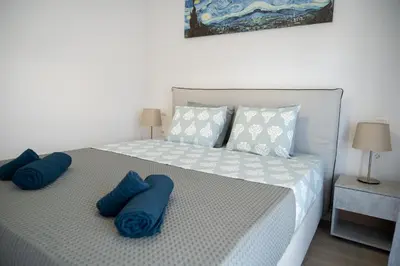 a bedroom with a large bed with blue pillows at Classy and stylish flat near Pagrati region (D2) in Athens