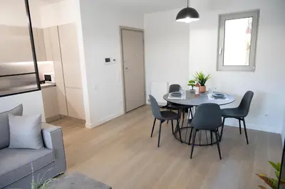 a living room with a table and chairs and a couch at Classy and stylish flat near Pagrati region (D2) in Athens