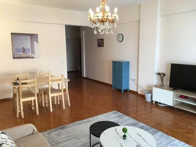 a living room with a table and a dining room at \u6d77\u5929\u4e4b\u84dd in Athens