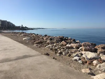 a group of rocks on a beach near the water at \u6d77\u5929\u4e4b\u84dd in Athens