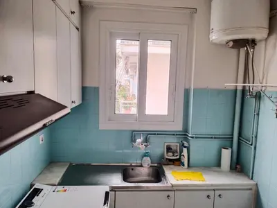 a small kitchen with a sink and a window at \u6d77\u5929\u4e4b\u84dd in Athens