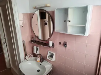 a pink bathroom with a sink and a mirror at \u6d77\u5929\u4e4b\u84dd in Athens