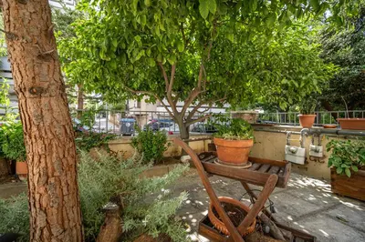 a garden with a bench and a tree at ANGEL , Luxury 2BD apartment next to the Beach in Athens