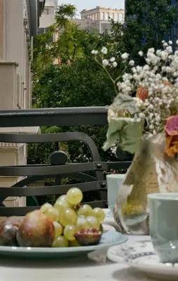 a plate of fruit on a table on a balcony at Luxury Athens Apartment 2 Bedrooms Apartment Mavis Spacious in Athens
