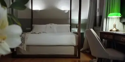 a bedroom with a bed and a table with a lamp at Amazing Athens Apartment 1 Bedroom Apartment Elfman Athinaidos in Athens