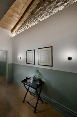 a room with a table with a plant on a wall at Stunning Athens Apartment 1 Bedroom Apartment Juvia Athinaidos in Athens