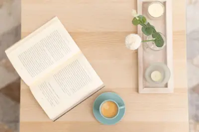 an open book and a cup of coffee on a table at Zografou House Living by 8essentially in Athens