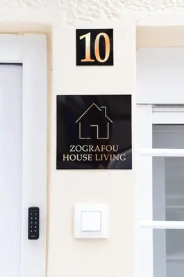 a sign on the side of a house living sign at Zografou House Living by 8essentially in Athens
