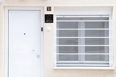 a white door with a window in front of it at Zografou House Living by 8essentially in Athens