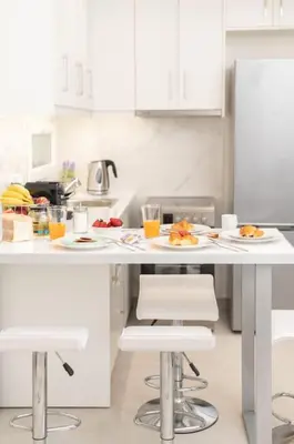 a kitchen with a table with plates of food on it at Zografou House Living by 8essentially in Athens