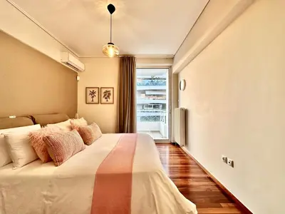 a bedroom with a bed and a window at Elaia Luxury Selection Amber in Athens