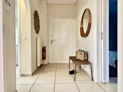 a hallway with a mirror on the wall and a table at Elaia Luxury Selection Amber in Athens