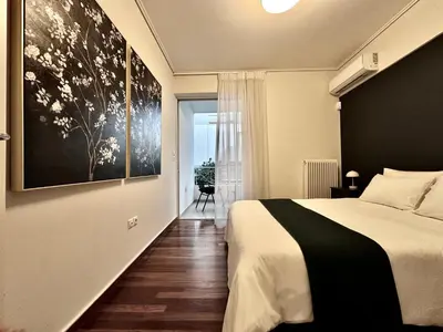 a bedroom with a bed and a large painting on the wall at Elaia Luxury Selection Amber in Athens