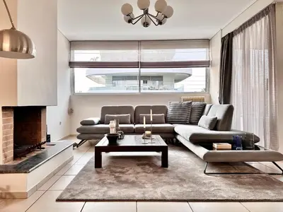 a living room with a couch and a fireplace at Elaia Luxury Selection Amber in Athens