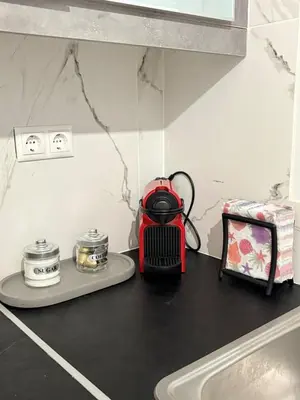 a kitchen counter with a red tea kettle on it at Guest house Elina in Kalívia Thorikoú