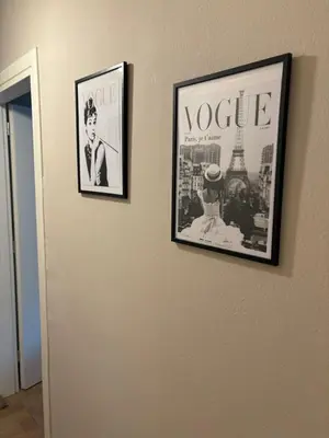two framed pictures on a wall with the eiffel tower at Guest house Elina in Kalívia Thorikoú