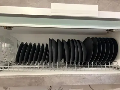 a shelf with a bunch of plates on it at Guest house Elina in Kalívia Thorikoú