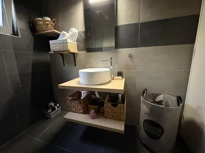 a bathroom with a sink and a mirror at Guest house Elina in Kalívia Thorikoú
