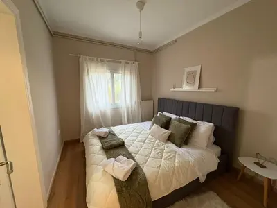 a small bedroom with a bed and a window at Guest house Elina in Kalívia Thorikoú