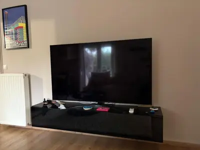 a large flat screen tv sitting on a wall at Guest house Elina in Kalívia Thorikoú