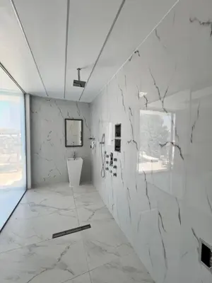 a white room with a marble wall at One Bedroom Pool House by Olivujoj in Anavissos
