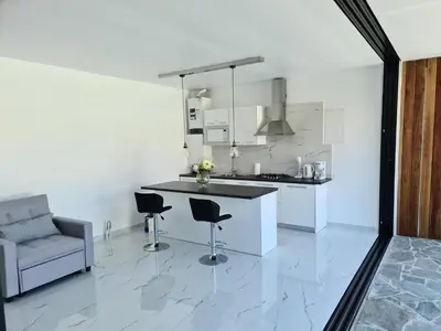 a kitchen with a counter and chairs in a room at One Bedroom Pool House by Olivujoj in Anavissos