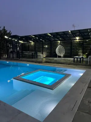a swimming pool at night with a blue pool at One Bedroom Pool House by Olivujoj in Anavissos