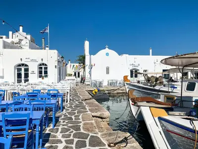 a group of blue chairs and boats in a harbor at Magnificent Athens Villa 1 Bedroom Villa Aizen Garden View in Athens