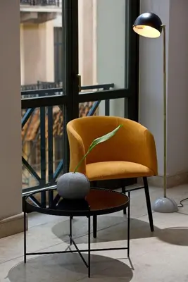 a yellow chair and a table with a plant on it at Delightful Athens Villa 1 Bedroom Villa Toshiro Thissio View in Athens