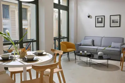 a living room with a couch and a table at Delightful Athens Villa 1 Bedroom Villa Toshiro Thissio View in Athens