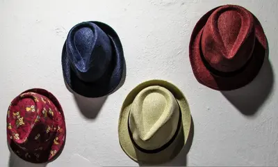 a group of hats hanging on a wall at Delightful Athens Villa 1 Bedroom Villa Toshiro Thissio View in Athens