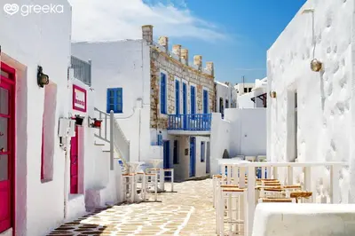 a street with white buildings and tables and chairs at Delightful Athens Villa 1 Bedroom Villa Toshiro Thissio View in Athens