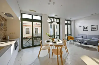 a kitchen and living room with a table and chairs at Delightful Athens Villa 1 Bedroom Villa Toshiro Thissio View in Athens