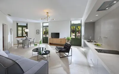 a living room with a couch and a table at Charming Athens Villa 1 Bedroom Villa Kyoraku Panoramic Acropolis View in Athens
