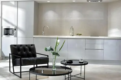 a living room with a chair and a table and a kitchen at Charming Athens Villa 1 Bedroom Villa Kyoraku Panoramic Acropolis View in Athens
