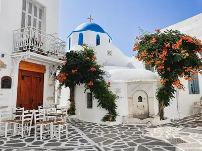 a white building with a chapel and tables and chairs at Luxury Athens Villa 2 Bedrooms Villa Yamamoto Thissio View in Athens
