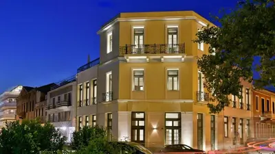 a yellow building with a balcony on the side of it at Luxury Athens Villa 2 Bedrooms Villa Yamamoto Thissio View in Athens
