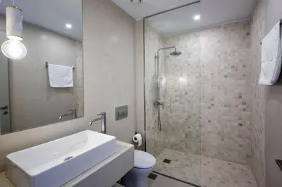 a bathroom with a sink and a shower and a toilet at Luxury Athens Villa 2 Bedrooms Villa Yamamoto Thissio View in Athens