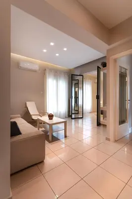 a living room with a couch and a table at Modern Faliro Flat in Athens
