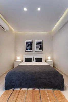 a bedroom with a large bed with two night stands at Modern Faliro Flat in Athens