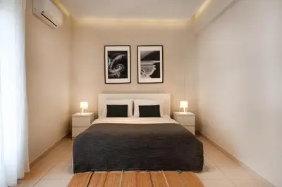 a bedroom with a large bed with two night stands at Modern Faliro Flat in Athens