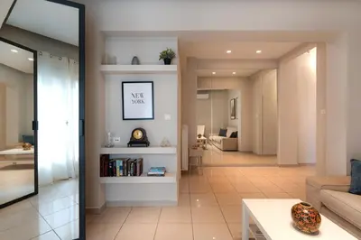 a living room with a couch and a table at Modern Faliro Flat in Athens