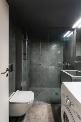 a bathroom with a shower and a toilet and a sink at Modern Faliro Flat in Athens