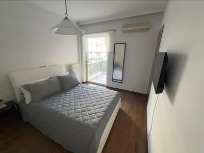 a bedroom with a bed and a television in it at glyfada luxury home in Athens
