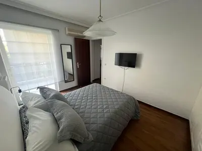 a bedroom with a bed with pillows on it at glyfada luxury home in Athens