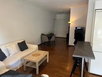 a living room with a white couch and a table at glyfada luxury home in Athens